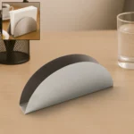 Keep your tissues neatly organized with this stainless steel napkin holder featuring a sleek half-moon design. Crafted from durable, rust-resistant stainless steel, this holder adds a modern touch to any dining table or workspace while ensuring easy access to your napkins. Key features • Sleek half-moon arc shape for a stylish and contemporary look • Made from sturdy stainless steel providing durability and rust resistance • Stable base prevents slipping or tipping on surfaces • Open slot design allows effortless tissue pulling and quick refills • Compact size fits standard napkins and saves table space • Easy to clean with a polished metallic finish • Perfect for homes, offices, cafes, and restaurants • Great gift idea for housewarmings and corporate events Materials & care Constructed entirely of premium stainless steel, this tissue holder resists rust and maintains its shine over time. Clean with a damp cloth and mild detergent. Avoid abrasive materials to preserve the polished finish.